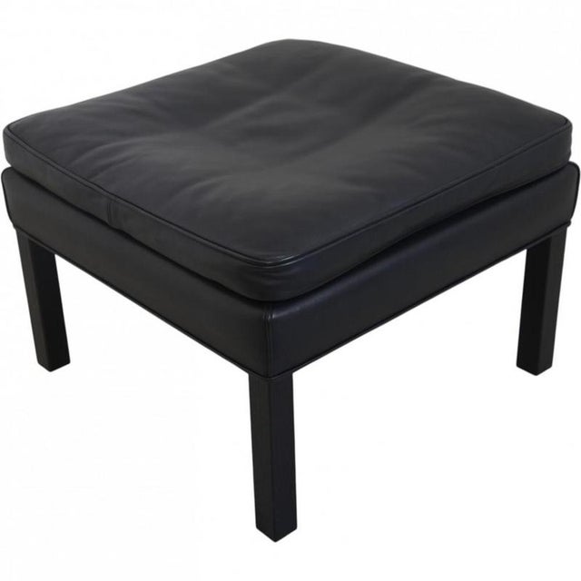 Børge Mogensen 2202 stool upholstered in black leather and with legs of black lacquered oak. The stool is from the 1990s...