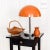 Lamp with a hemispherical lampshade characteristic for the 1960s. Made of metal, varnished in orange with a slightly...