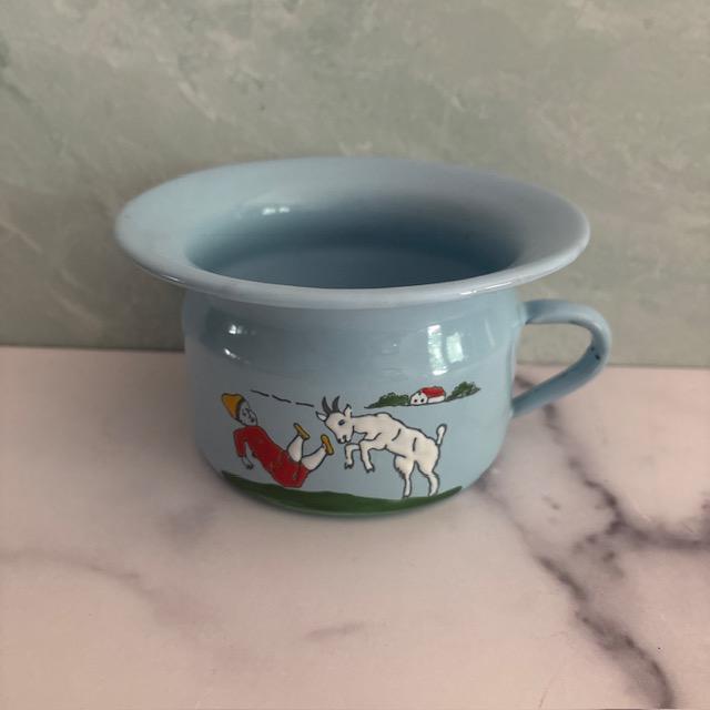 Fun vintage mid-century child's bowl. Made of coated and hand-painted tin, depicting a goat pushing over a child dressed...