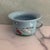 Fun vintage mid-century child's bowl. Made of coated and hand-painted tin, depicting a goat pushing over a child dressed...