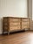 Vintage rattan and bamboo six-drawer dresser with geometric detailing, the woven surfaces creating a rich, textural...