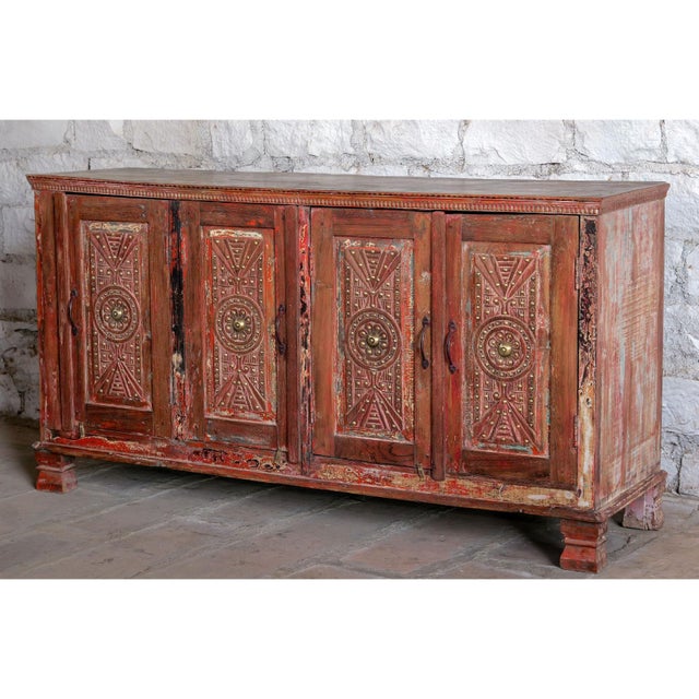 Elevate your space with this exquisite antique carved sideboard, featuring four beautifully detailed doors adorned with...