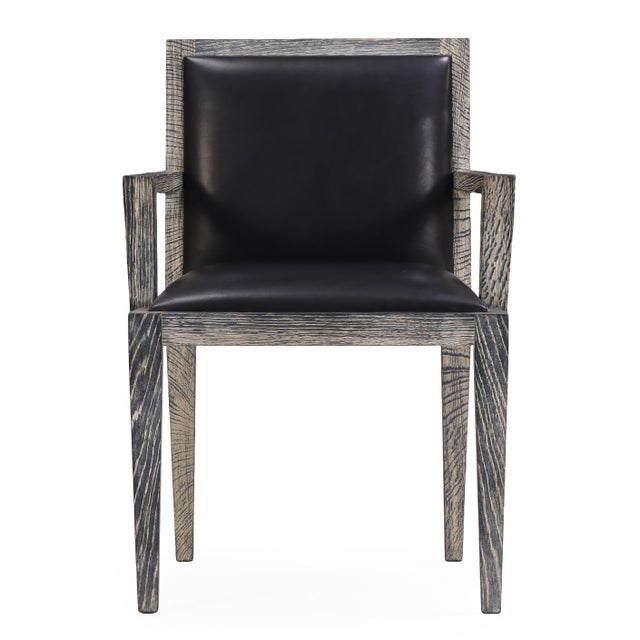 A sleek set of four French armchairs in cerused oak, the frames feature clean, angular lines that highlight the dramatic...