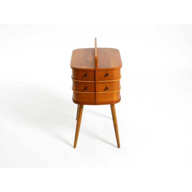 Original Mid Century Modern folding sewing box in very good vintage condition. The entire box is made of plywood with teak...