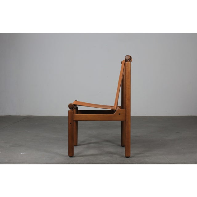 Set of twelve dining chairs with wooden frame, seat and back in leather designed by Ilmari Tapiovaara and produced by La...