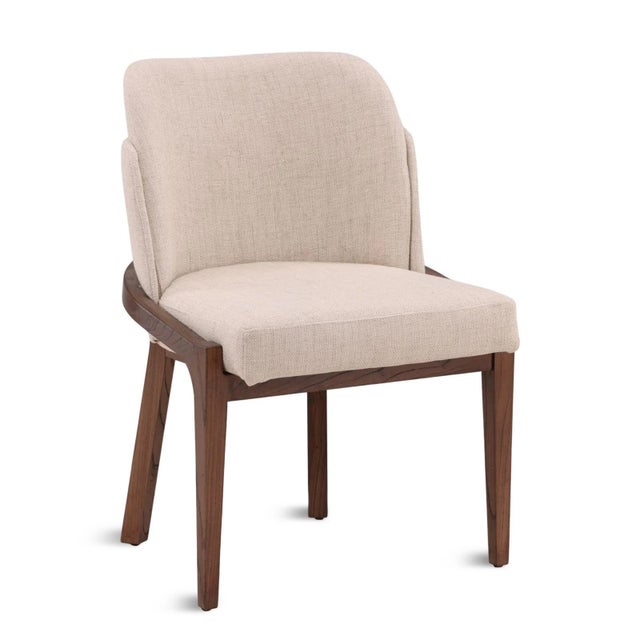 Upholstered contemporary dining chair which brings easy sophistication to any dining space. Beautiful grained walnut...