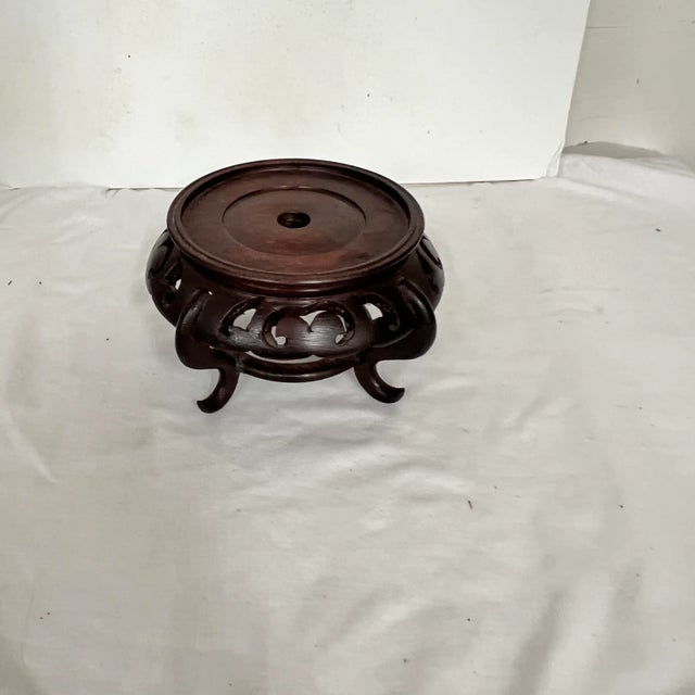 Chinoiserie mahogany footed plant / display stand. Measures 6.5” diameter x 4” h. Holds a container up to 4.5” on bottom.