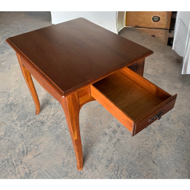 “Ethan Allen Madison” collection includes various Country French-inspired pieces including this end table. Crafted from...