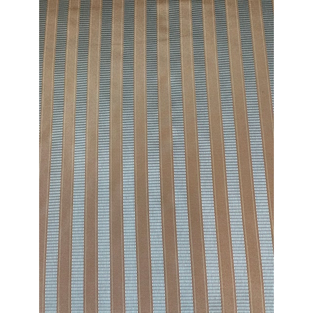 Elegant handmade bamboo armchair with woven seat and back and a large silk striped light blue pillow with feather down...