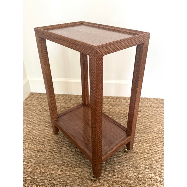 Karl Springer Snakeskin Telephone Table/Side table. Covered in a warm toffee snakeskin. On brass castors. Moire burgundy...