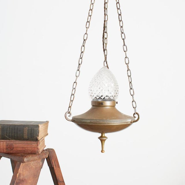 A stunning brass church sanctuary pendant light with a cut glass shade it retains its hanging chains and ceiling plate. It...