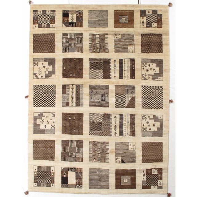 Vintage hand-knotted Persian Fine Lori Gabbeh rug featuring a striking grid of varied tribal motifs and patchwork panels....