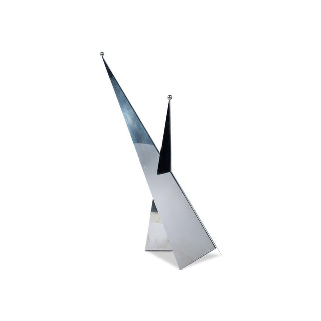 Table lamp with a low chrome-plated metal frame, featuring a graphic, horizontal design typical of Italian design from...