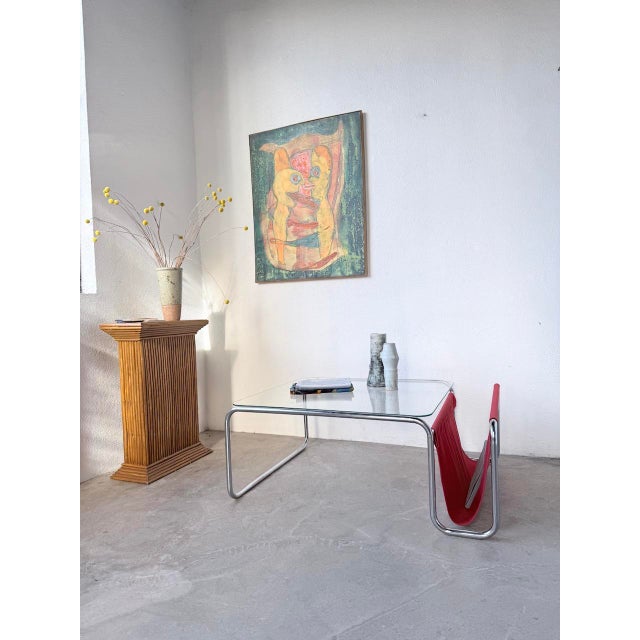 Vintage 1970s bauhaus-inspired coffee table with a chromed tubular steel base. the table features a clear glass top and a...