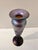 This signed hand‑blown art glass vessel features a tall, slender silhouette with a flared rim and wide base. The surface...