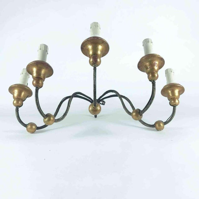 Antique five-light iron wall sconce, early 19th-century candelabra with five curved double-volute arms, decorated with...