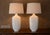 Amazing pair of mid century modern white ceramic table lamps with a crackle finish. Stunningly sculptural in form with a...