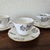 A charming set of four vintage Spode fine bone china teacups with matching saucers, crafted in England in the discontinued...