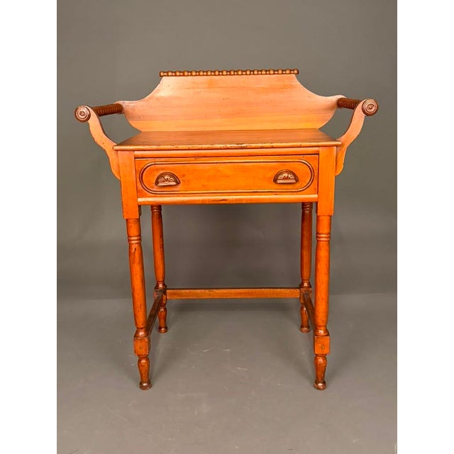 A charming late 19th-century American Victorian wash stand, circa 1880, showcasing the craftsmanship and functional design...