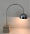 Very cool arc table or desk lamp in chrome, anchored with square travertine block base. Made in Italy by Harvey Guzzini....