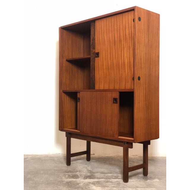 A 1960s Italian-made highboard bookcase. The piece is produced by Boravero, Turin, and is made of solid wood with teak...