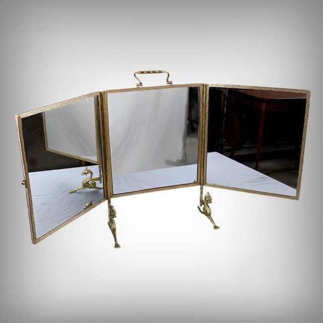 A superb triptych mirror in bronze, remarkable for its refined decoration and elegant composition. The three mirrors,...