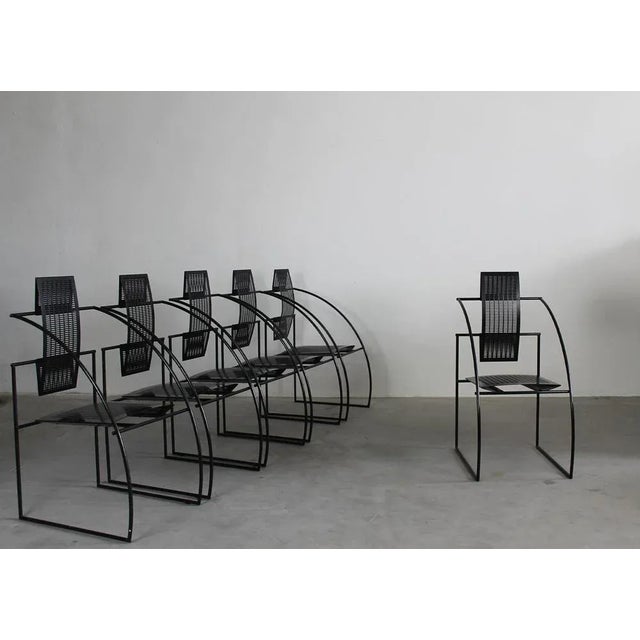 Set of six chairs quinta, with a black steel rod frame, seat and back in bent perforated sheet metal. Designed by mario...
