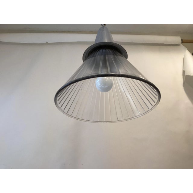 Pendant light made from an antique French glass funnel, uses an Edison base bulb up to 100 watts.