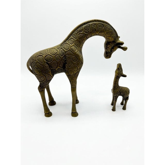 Elevate your space with this charming vintage pair of solid brass giraffe figurines from the Leonard Silver Mfg. Co. Solid...