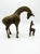Elevate your space with this charming vintage pair of solid brass giraffe figurines from the Leonard Silver Mfg. Co. Solid...