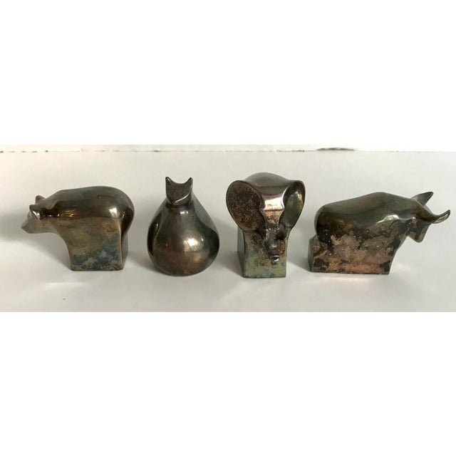 Here is a lovely set made by Dansk of a cat, bear, elephant and bull silver animal figurine that can serve as a...