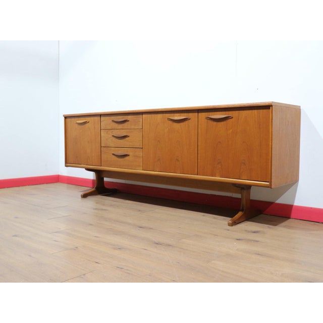 A stunning sideboard made by renowned British furniture maker Austinsuite, this Mid Century Modern Vintage Teak Credenza...