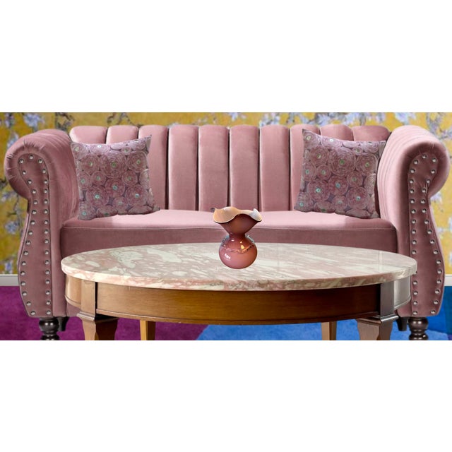 This Art Glass vase is hand crafted from mauve-colored glass and features an inner layer of cased white glass. The vase...