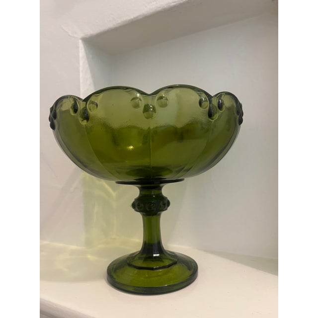 Large vintage bowl on a pedestal by Indiana Glass. Made in the 90’s in thick glass of a gorgeous green color. The bowl has...