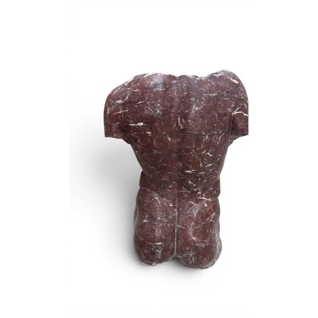 Elegant sculptural representation of a male torso carved in richly colored Italian red marble. Inspired by the fragmented...