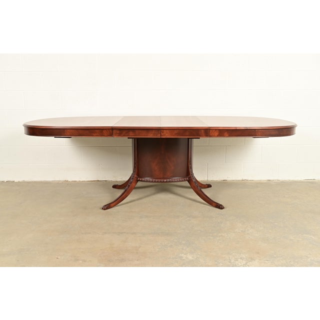 A gorgeous Georgian or Regency style flame mahogany pedestal extension dining table By Romweber USA, Circa 1920s Measures:...