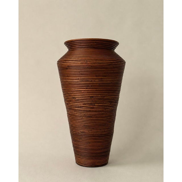 A vintage 1970's handcrafted pencil reed floor vase in a classic amphora form and a finish that shifts from warm honey to...