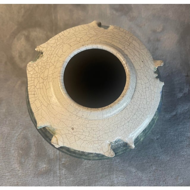 This vintage fired raku art pottery vase features an exquisite combination of turquoise, jade, and aquamarine colors and...