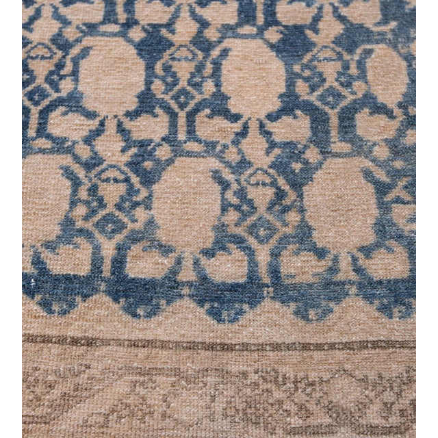 This Malayer rug has a deep indigo-blue field with an overall design of linked buff-brown angular vine linking floral...