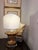 A sculptural table lamp created from an antique carved giltwood architectural fragment, thoughtfully reimagined into a...