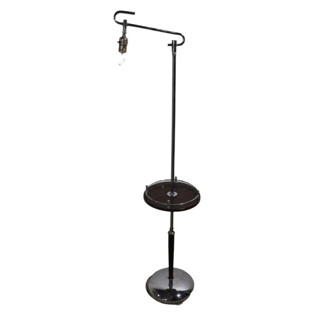 Classic Machine Age - Art Deco floor, reading lamp, in chrome and brown faux wood finish. The lamp features a stylized S...