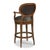 A graceful bar stool built for comfort. An upholstered oval back accented with brass nails is situated above an...