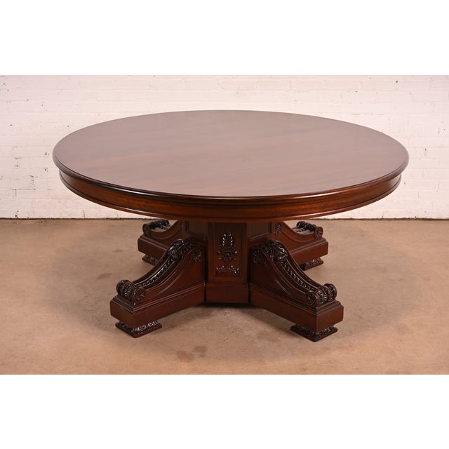 An outstanding antique Victorian or Renaissance Revivial carved mahogany pedestal dining table In the manner of R. J....