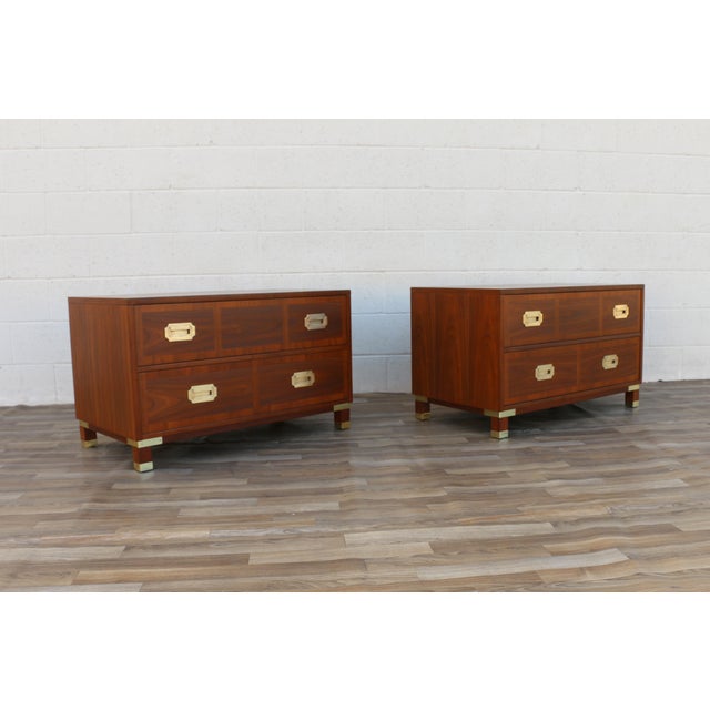 An exceptional pair of Mid-Century Modern campaign-style nightstands by Milling Road Furniture, a division of Baker...