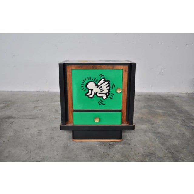 Bedside tables in walnut painted with acrylics on all sides.