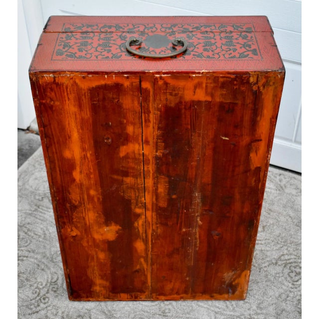 Antique (1900s) Trunk on Stand is Asian. Made of Wood that has been Painted a Cinnabar Color with a Design. Brass Handles....