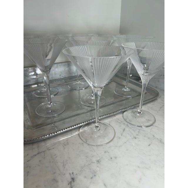 An elegant set of eight crystal martini glasses by Tiffany & Co. Each glass features a classic conical bowl embellished...