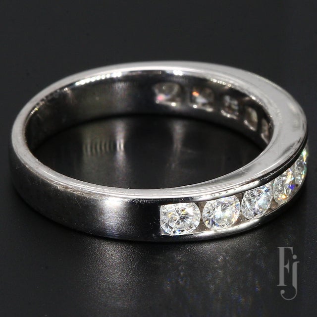 This is an 18k White Gold Ring with Eleven Round Channel Set Diamonds weighing ~0.10cts. each. Size - 6.25 Total Weight -...