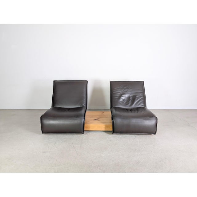 We are offering a beautiful two-seater sofa, the "Edit - Free Motion" by Koinor, for sale. The sofa consists of a wooden...