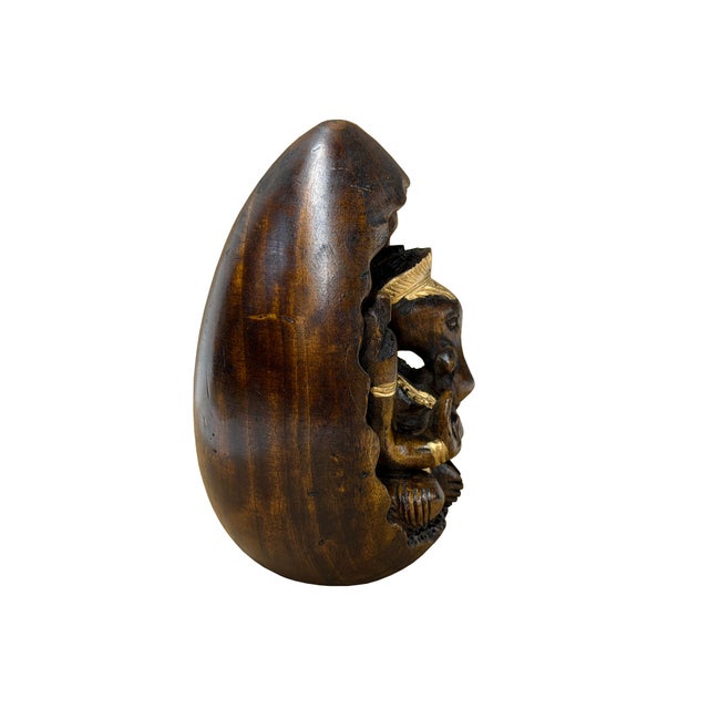 Invite peace, prosperity, and striking artistry into your home with this magnificent hand-carved wooden Lord Ganesha...